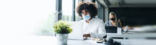 Busy mortgage originator in office, masked