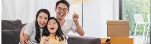 Happy couple with child who used mortgage technology to get loan moving into new home