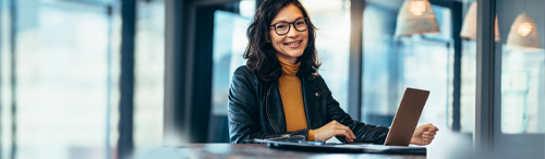 Happy woman borrower using computer to access mortgage lender website